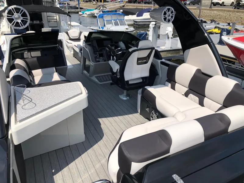 Slide: The Image of 2024 Avalon Excalibur 27' luxury pontoon boat interior with plush seating and modern helm. - 8