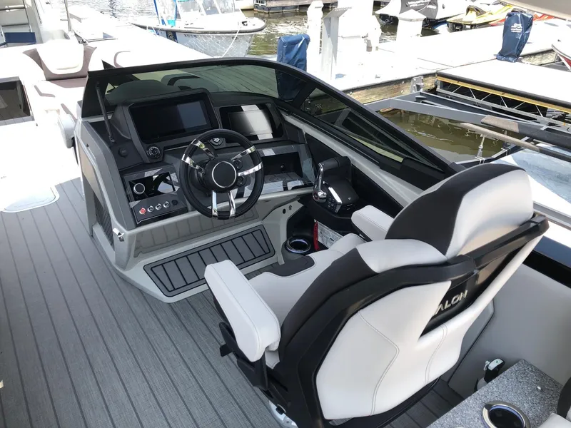 Slide: The Image of 2024 Avalon Excalibur 27' boat cockpit with modern steering and control panel. - 9