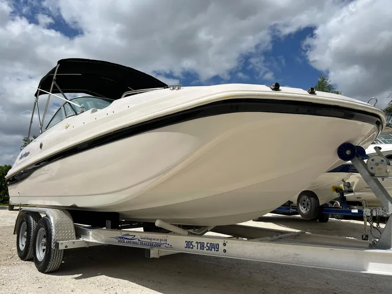 Slide: The Image of 2002 Hurricane 194 boat on a trailer under a cloudy sky. - 10