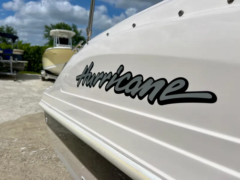 Slide: The Image of Close-up of a 2002 Hurricane 194 boat with logo. - 14