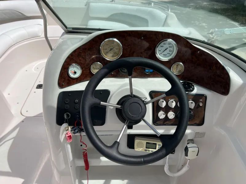 Slide: The Image of Steering console of a 2002 Hurricane 194 boat with gauges and controls. - 15