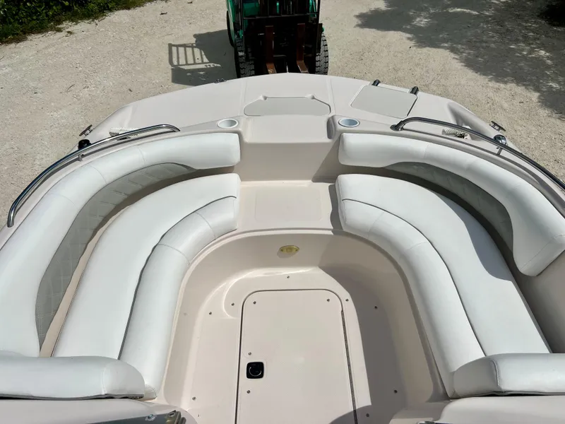 Slide: The Image of 2002 Hurricane 194 boat with white cushioned seating and storage compartments. - 16