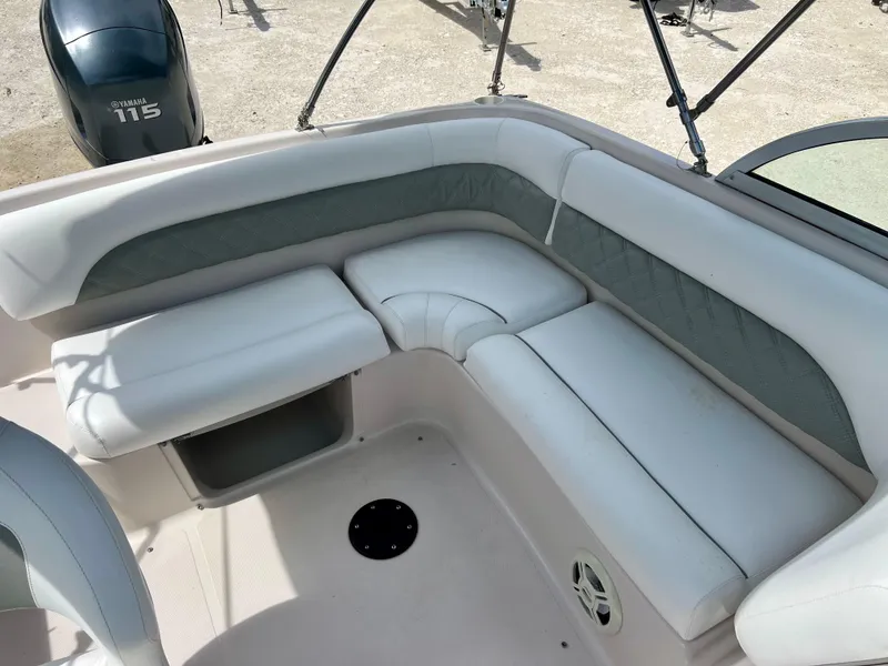 Slide: The Image of 2002 Hurricane 194 boat interior with cushioned seating and Yamaha 115 outboard motor. - 21