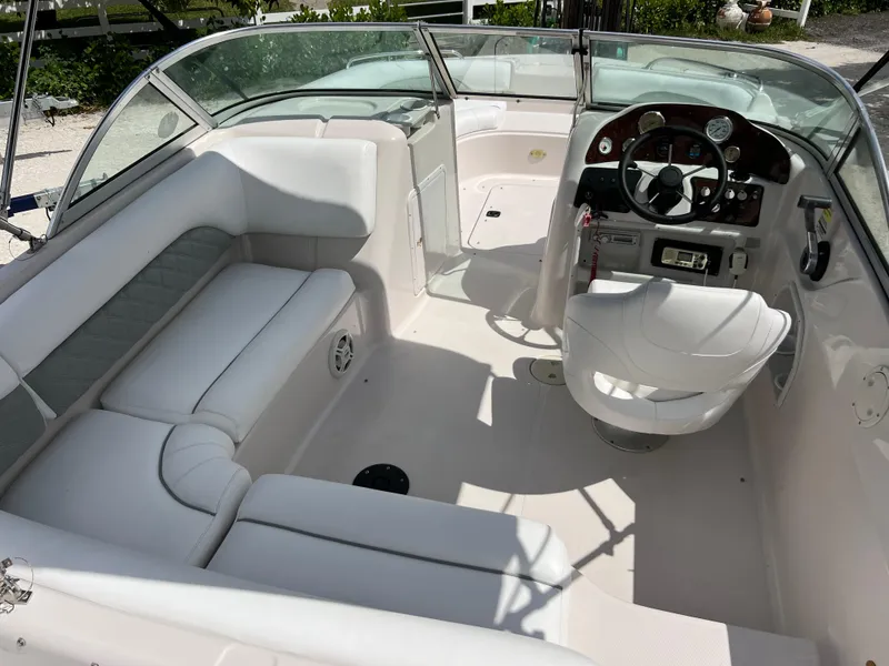 Slide: The Image of Interior of a 2002 Hurricane 194 boat with white seating and steering console. - 24