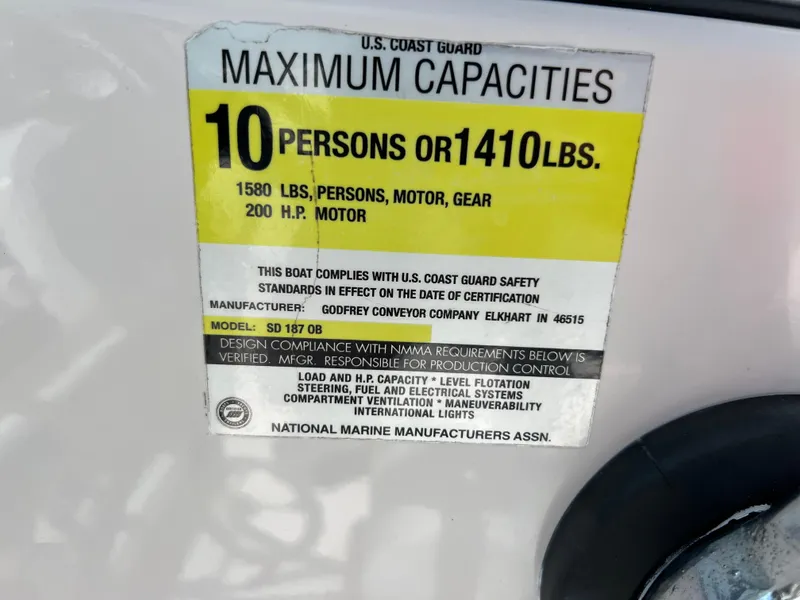 Slide: The Image of 2002 Hurricane 194 boat capacity label: 10 persons or 1410 lbs, 200 HP motor. - 25