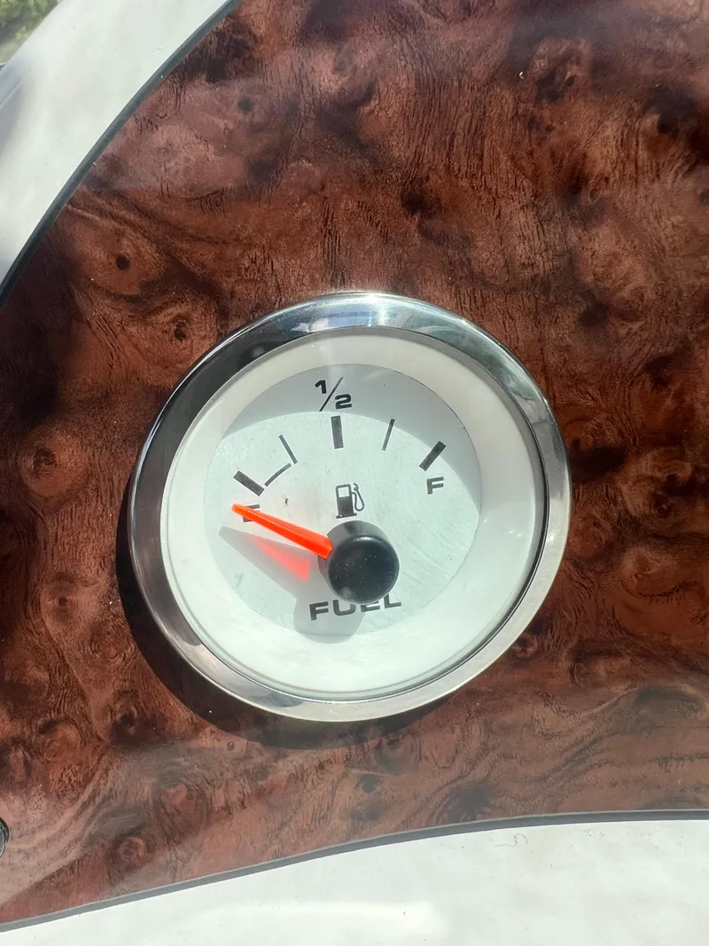 Slide: The Image of Fuel gauge of a 2002 Hurricane 194 boat with a wooden dashboard. - 29