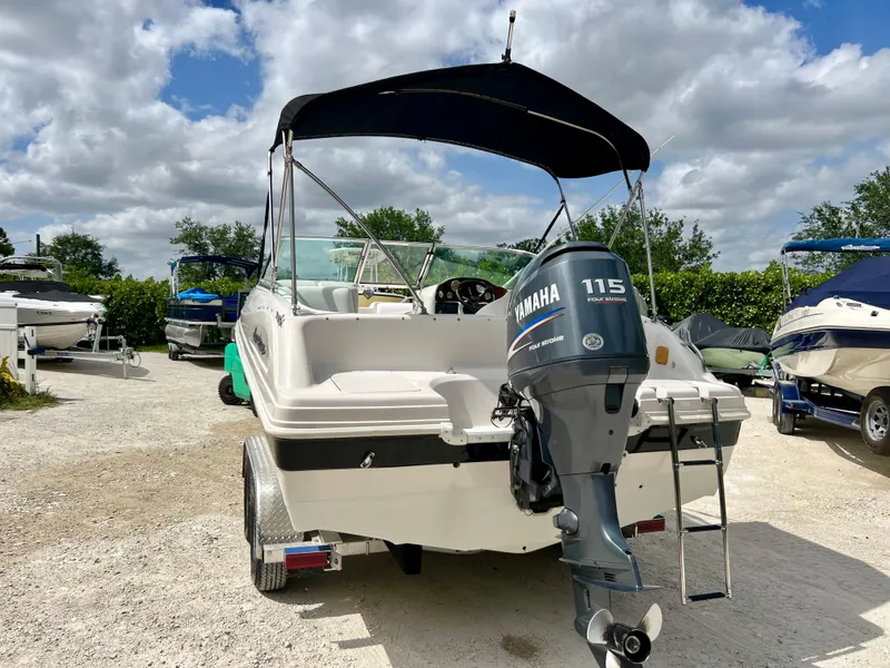 Slide: The Image of 2002 Hurricane 194 boat with Yamaha 115 outboard motor in a marina. - 33