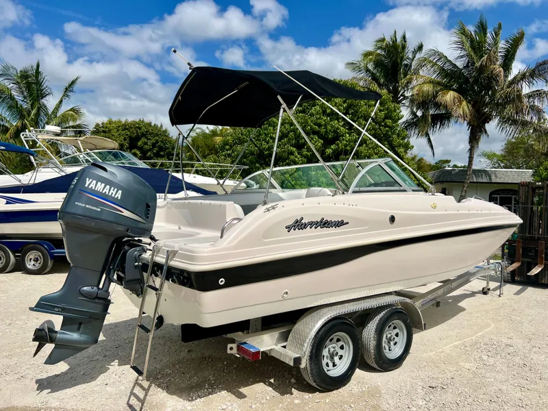 Slide: The Image of 2002 Hurricane 194 boat with Yamaha outboard motor on trailer. - 34