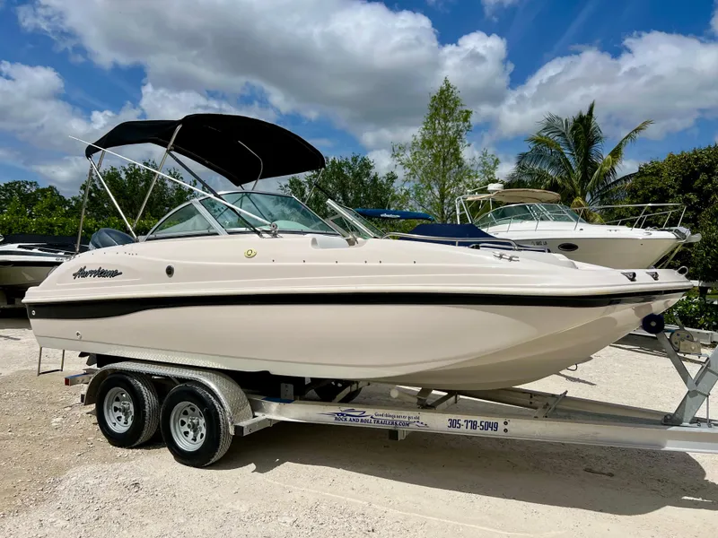 Slide: The Image of 2002 Hurricane 194 boat on a trailer under a blue sky. - 4