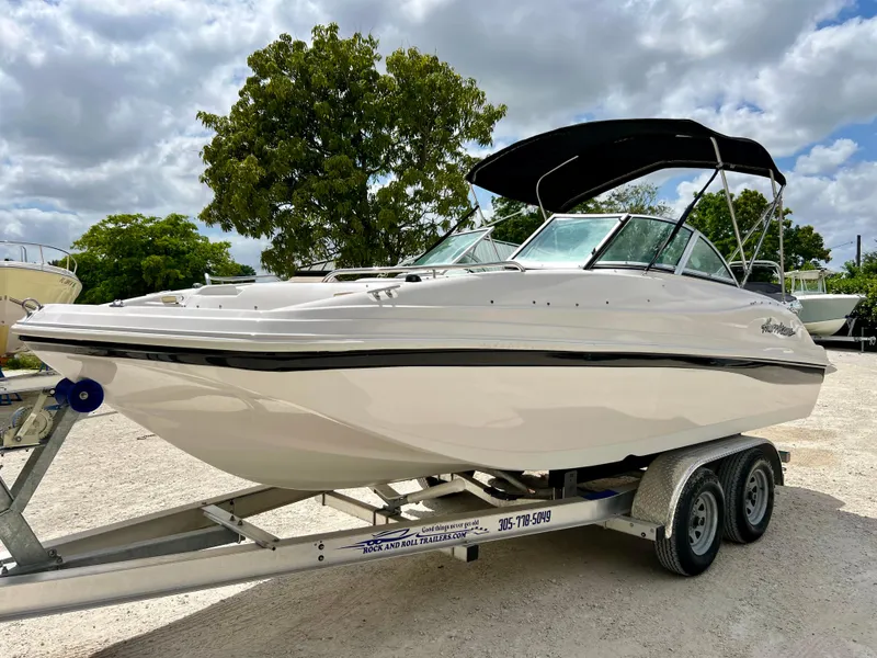 Slide: The Image of 2002 Hurricane 194 boat on a trailer with a black canopy. - 5