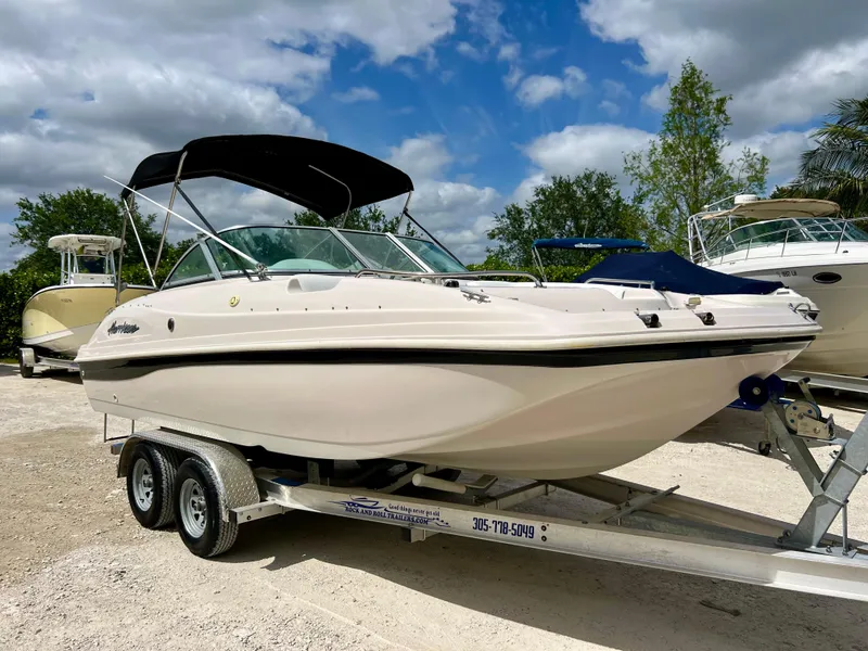 Slide: The Image of 2002 Hurricane 194 boat on a trailer with a black canopy. - 8