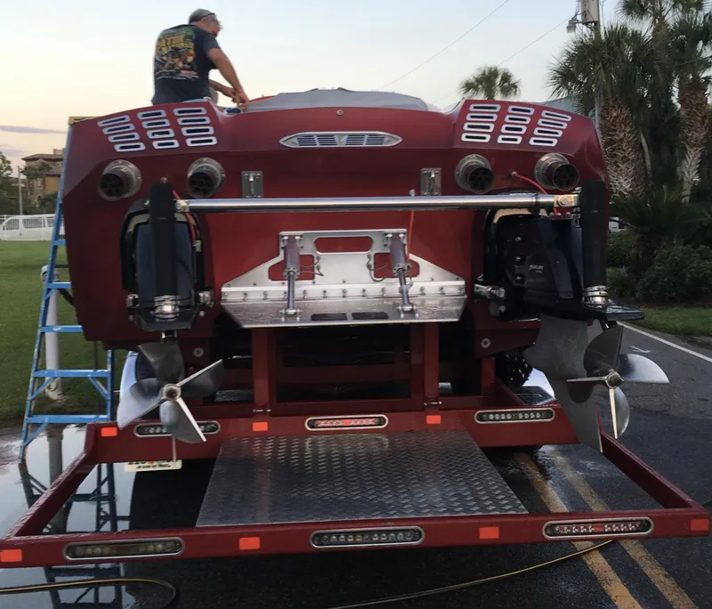 Slide: The Image of 2007 Eliminator 36 Daytona Coupe speedboat on trailer, rear view with propellers visible. - 4
