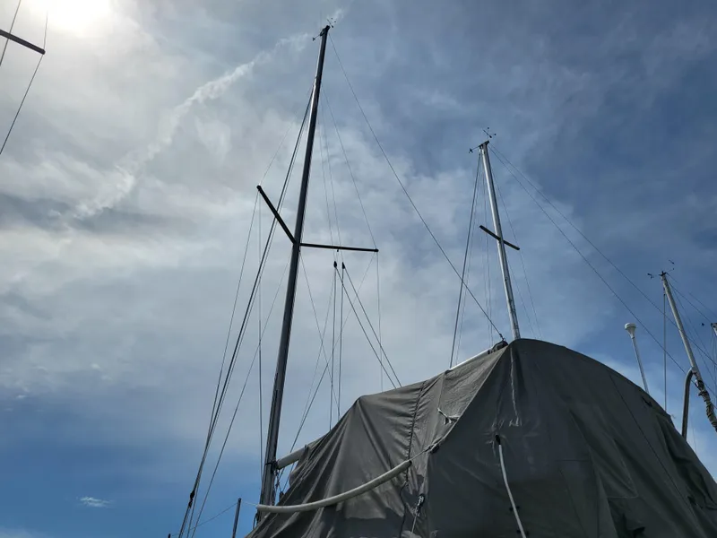 Slide: The Image of 1998 Hunter 280 sailboat with covered hull and masts. - 16