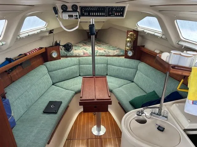 Slide: The Image of Interior of a 1998 Hunter 280 yacht with green upholstery. - 3
