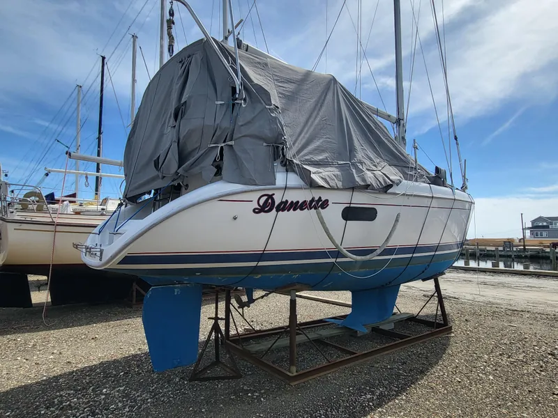 Slide: The Image of 1998 Hunter 280 sailboat on dry dock, partially covered. - 8