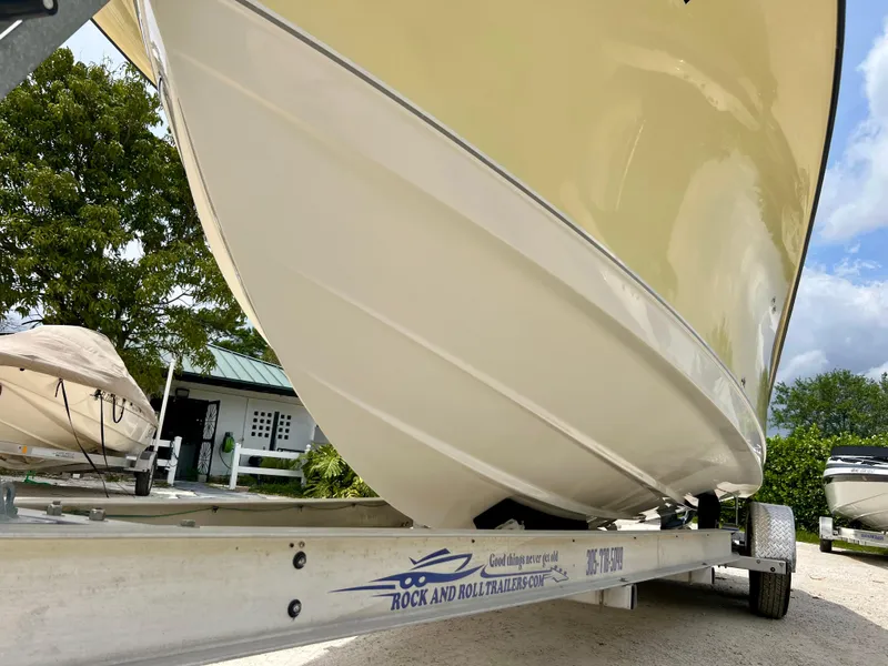 Slide: The Image of 2008 Trophy 2503 boat on Rock and Roll trailer, side view. - 15