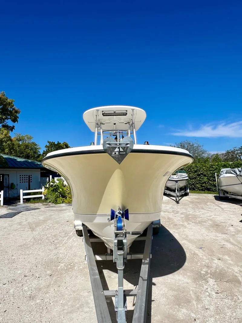 Slide: The Image of 2008 Trophy 2503 boat on trailer under clear blue sky. - 16