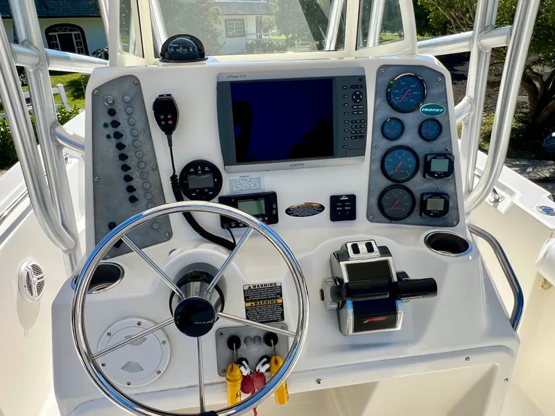 Slide: The Image of 2008 Trophy 2503 boat dashboard with steering wheel, gauges, and navigation equipment. - 20