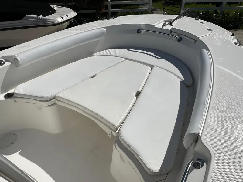 Slide: The Image of 2008 Trophy 2503 boat with white cushioned seating area. - 21