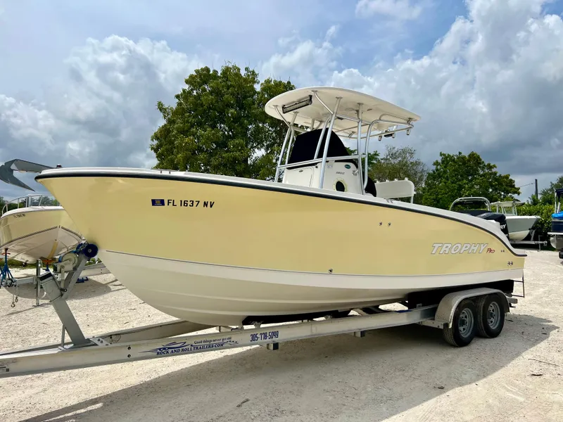 Slide: The Image of 2008 Trophy 2503 boat on a trailer in a parking lot. - 3