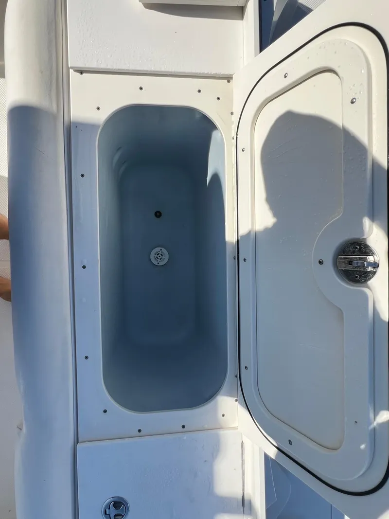 Slide: The Image of 2008 Trophy 2503 boat storage compartment with open lid. - 30