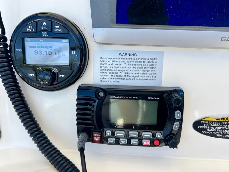 Slide: The Image of 2008 Trophy 2503 boat dashboard with JBL radio and Standard Horizon Explorer. - 33