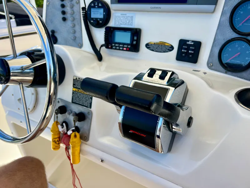 Slide: The Image of Control panel of a 2008 Trophy 2503 boat with steering wheel and throttle. - 34