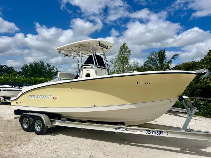 Slide: The Image of 2008 Trophy 2503 boat on trailer under blue sky. - 4