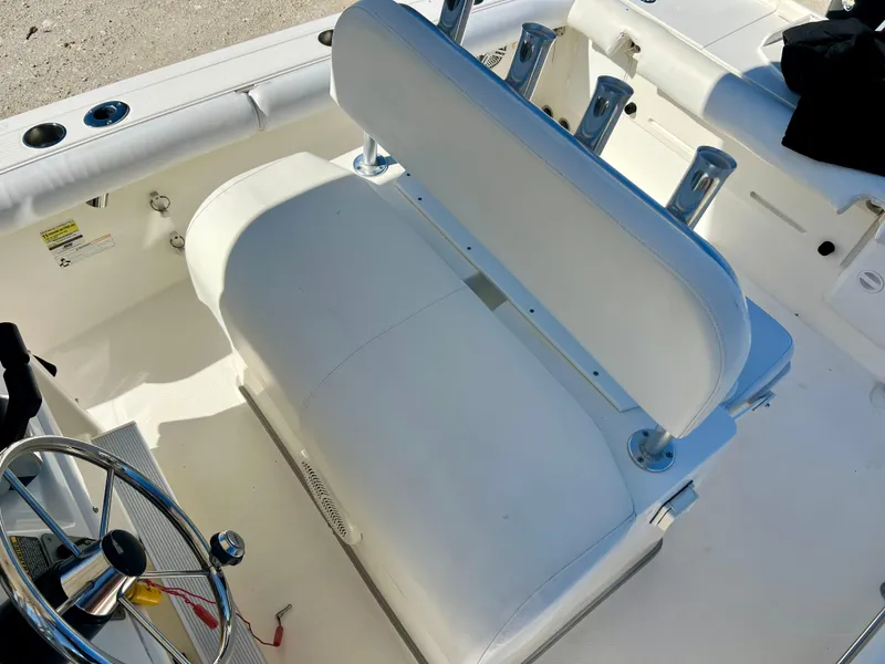 Slide: The Image of 2008 Trophy 2503 boat cockpit with white seating and steering wheel. - 45