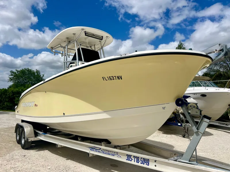 Slide: The Image of 2008 Trophy 2503 boat on trailer under blue sky. - 5