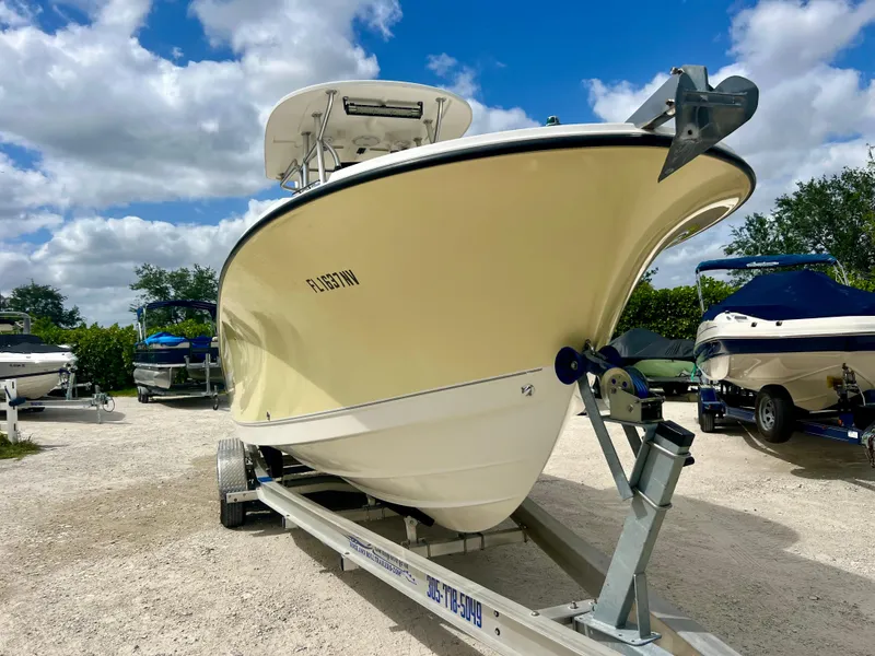 Slide: The Image of 2008 Trophy 2503 boat on trailer under a partly cloudy sky. - 6