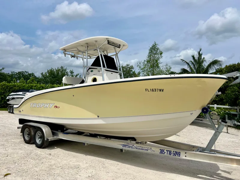 Slide: The Image of 2008 Trophy 2503 Pro boat on a trailer in a parking lot. - 9