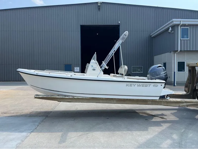 Slide: The Image of 2024 Key West 1720 CC boat on trailer outside industrial building. - 1
