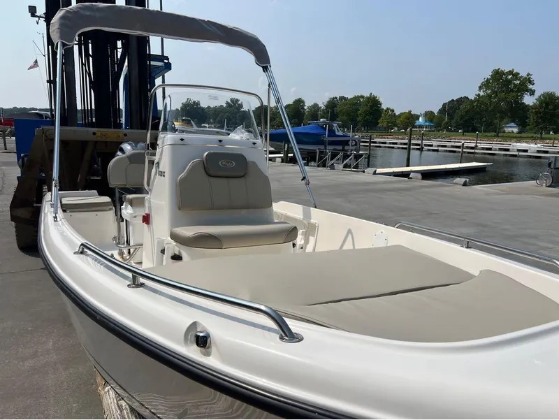 Slide: The Image of 2024 Key West 1720 CC boat docked at marina, featuring sleek design and comfortable seating. - 12