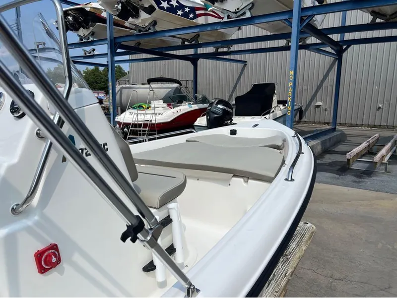 Slide: The Image of 2024 Key West 1720 CC boat in storage facility, featuring sleek design and Mercury engine. - 8