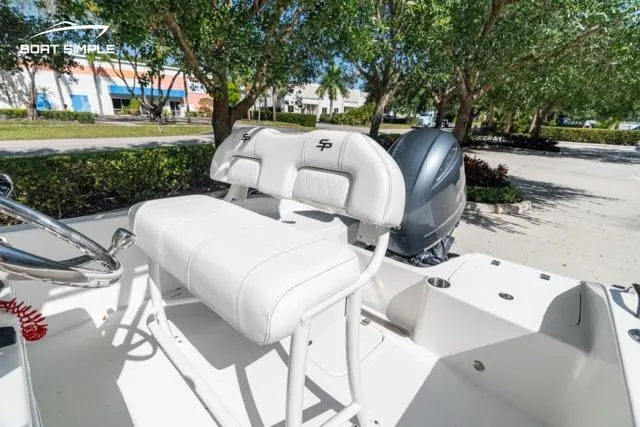 Slide: The Image of 2023 Sea Pro 199 Deep V Center Console boat with white seating and outboard motor. - 11