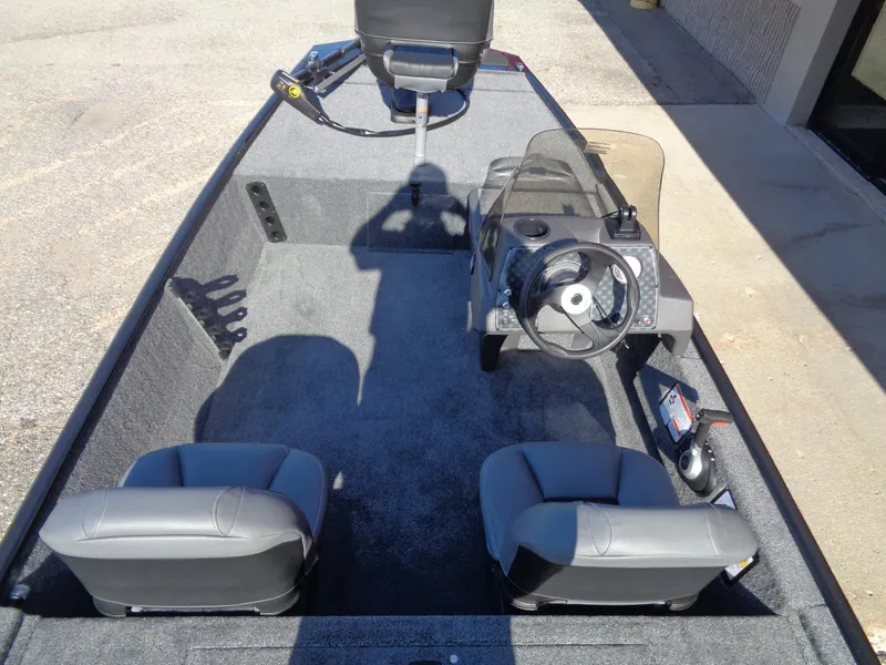 Slide: The Image of 2024 Tracker Bass Tracker Classic XL boat interior with seating and steering console. - 4
