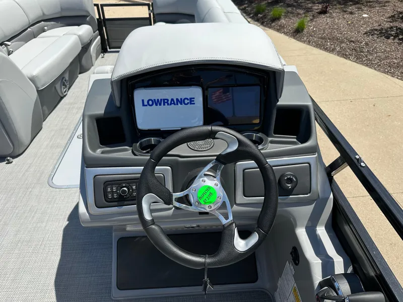 Slide: The Image of 2024 Regency 250 DL3 boat dashboard with Lowrance navigation system and steering wheel. - 4