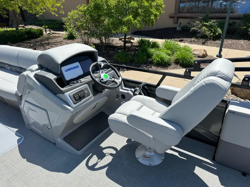 Slide: The Image of 2024 Regency 250 DL3 boat cockpit with steering wheel and captain's chair. - 5