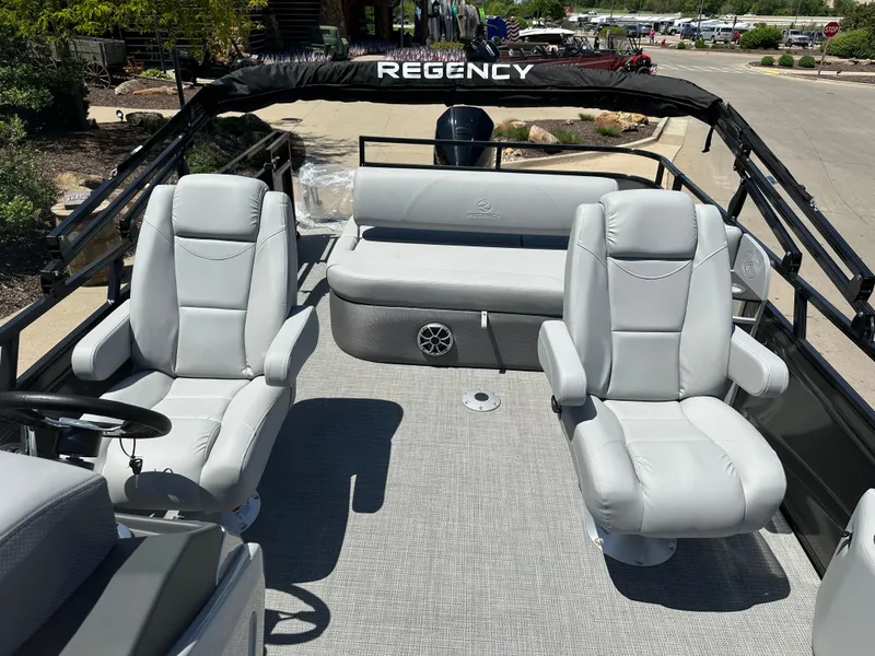 Slide: The Image of 2024 Regency 250 DL3 pontoon boat with luxurious seating and spacious deck. - 6