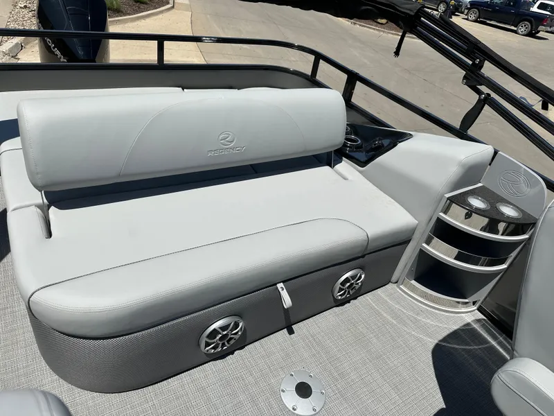 Slide: The Image of 2024 Regency 250 DL3 boat interior with gray seating and built-in speakers. - 7
