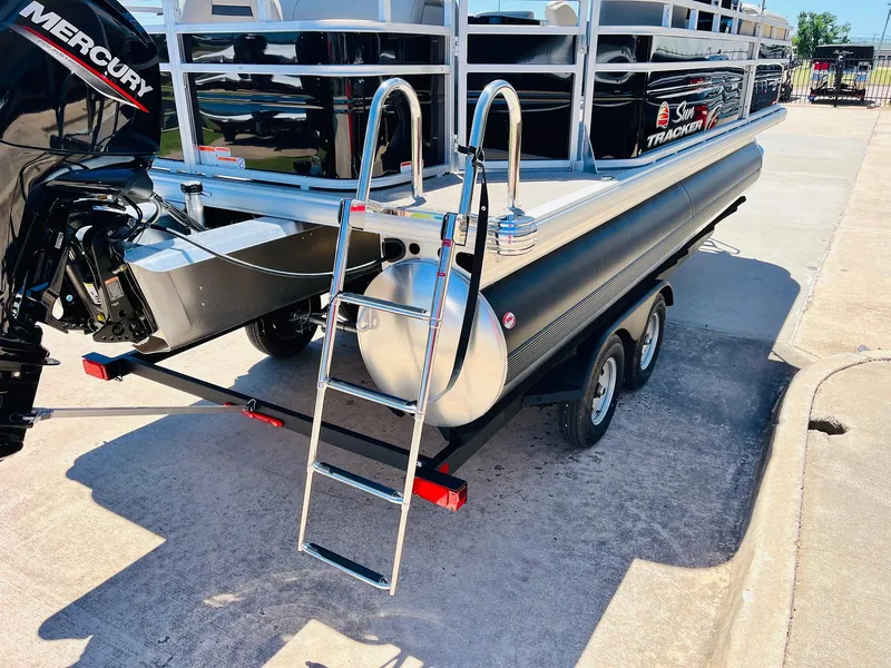 Slide: The Image of 2024 Sun Tracker SportFish 20 DLX pontoon boat with Mercury engine and trailer. - 10