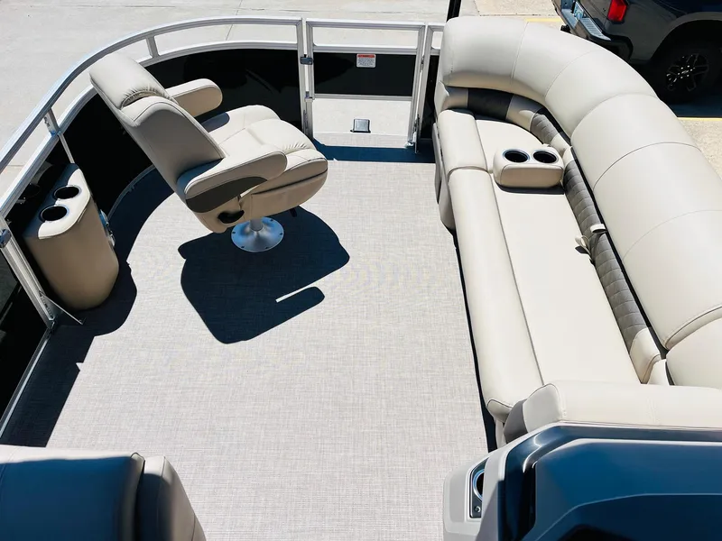 Slide: The Image of 2024 Sun Tracker SportFish 20 DLX pontoon boat interior with plush seating and cup holders. - 12