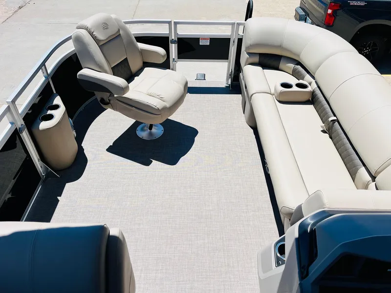 Slide: The Image of 2024 Sun Tracker SportFish 20 DLX pontoon boat interior with plush seating and captain's chair. - 13