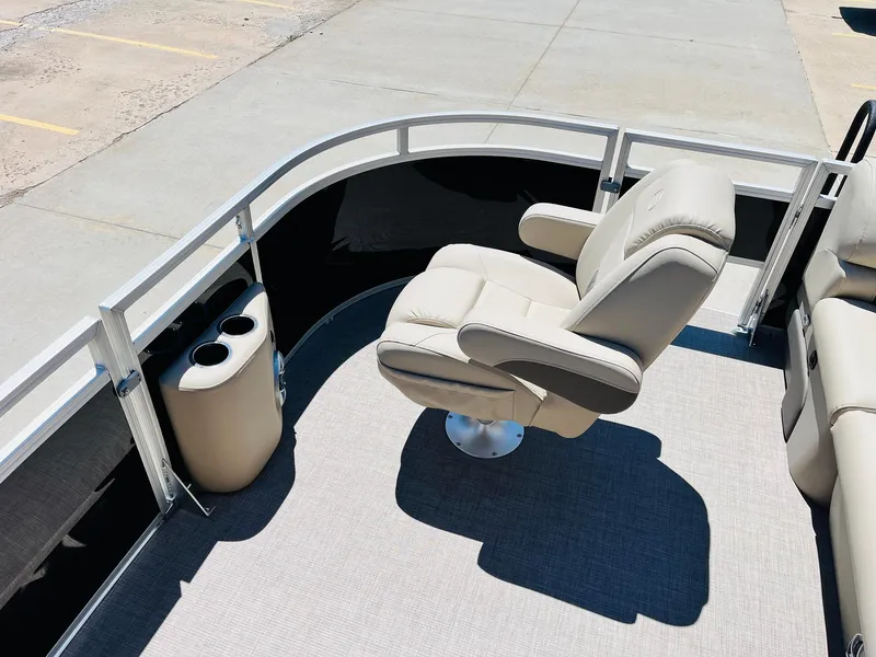 Slide: The Image of 2024 Sun Tracker SportFish 20 DLX boat interior with plush seating and cup holders. - 15