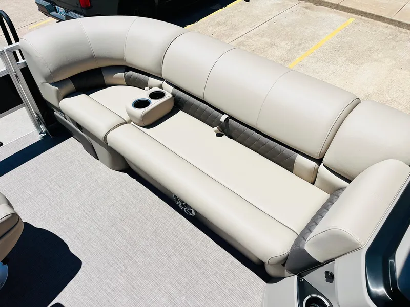 Slide: The Image of 2024 Sun Tracker SportFish 20 DLX pontoon boat with beige seating and cup holders. - 17