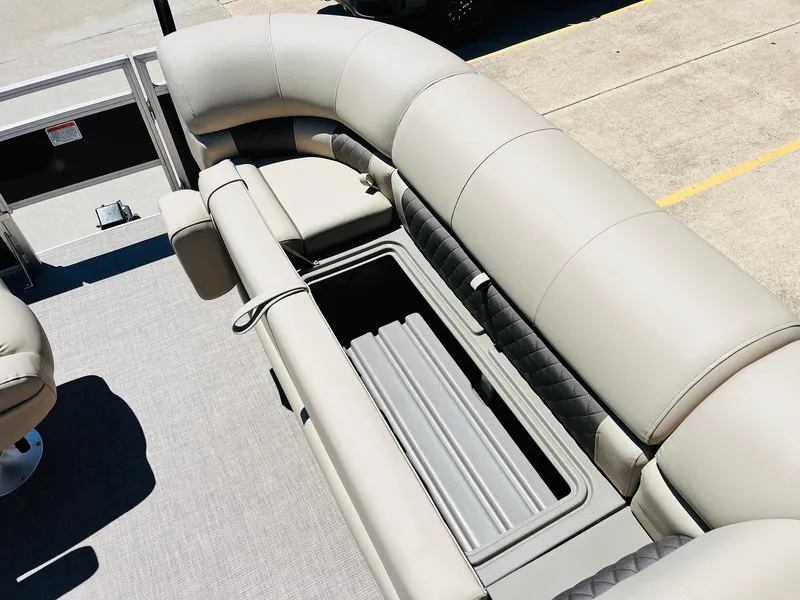 Slide: The Image of 2024 Sun Tracker SportFish 20 DLX boat interior with cushioned seating and storage compartment. - 19
