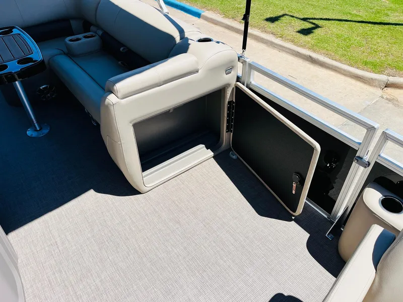Slide: The Image of 2024 Sun Tracker SportFish 20 DLX pontoon boat interior with open storage compartment. - 22