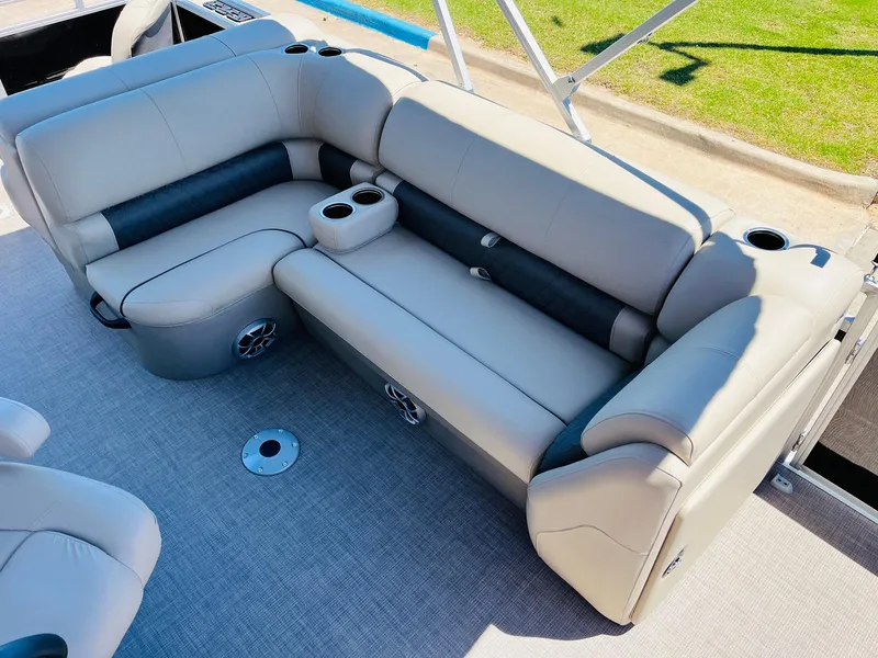Slide: The Image of 2024 Sun Tracker SportFish 20 DLX boat interior with plush seating and cup holders. - 24