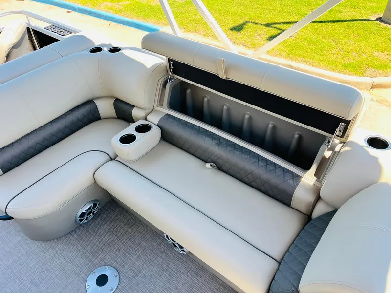 Slide: The Image of 2024 Sun Tracker SportFish 20 DLX boat interior with cushioned seating and cup holders. - 25